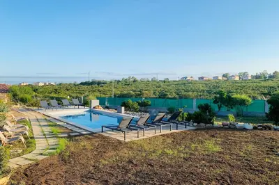 an aerial view of a swimming pool with lounge chairs at appart Libeccio swimming pool bbq in Calenzana