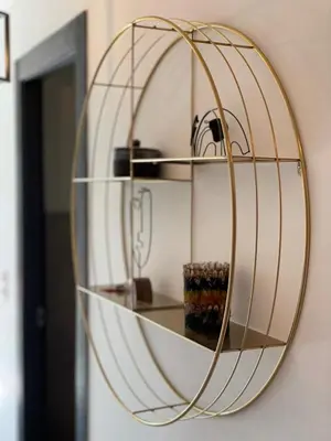 a round mirror hanging on a wall at Superbe appartement sur le port, jacuzzi, piscine in Porto-Vecchio