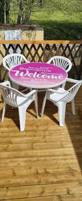 a table and two chairs sitting around a patio table and chairs at Le coin tranquille in Morosaglia