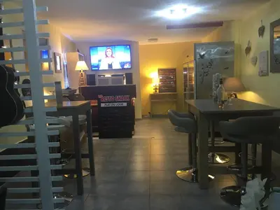 a restaurant with tables and a tv in a room at La Caravane LE NID DOUILLET in Ponte-Leccia