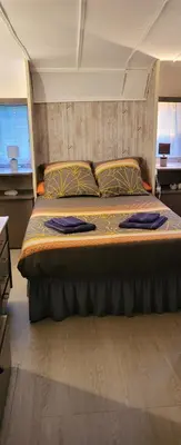 a bedroom with a large bed in a room at La Caravane LE NID DOUILLET in Ponte-Leccia