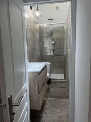 a bathroom with a white sink and a toilet at Appartement T2 vieille ville d’Ajaccio in Ajaccio