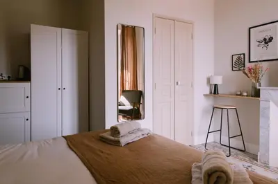 a bedroom with a bed with towels on it at L'Orangeraie d'Afa in Afa