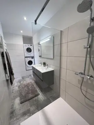 a bathroom with a sink and a washing machine at Un petit paradis in Pinarellu