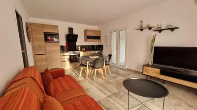 a living room with a couch and a table at Petite maison en pierre in Afa