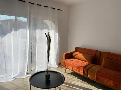 a living room with a couch and a table at Petite maison en pierre in Afa