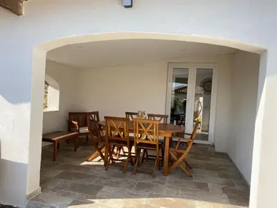 a dining room with a table and chairs at Petite maison en pierre in Afa