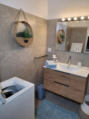 a bathroom with a sink and a mirror at Studio bord de mer - Plage - Piscine - Wifi in Santa-Lucia-di-Moriani