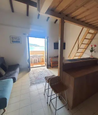 a living room with a couch and a table and chairs at Apartment Liscia sea view, restaurant and supermarket 50m in Calcatoggio
