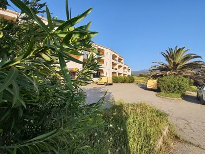 a building with a lot of green plants in front of it at Apartment Liscia sea view, restaurant and supermarket 50m in Calcatoggio