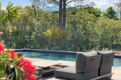 a swimming pool with two chairs and a table at Villa Ribba Di San Gavino in Gialla