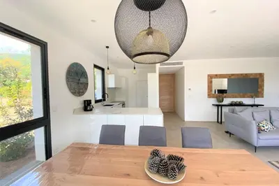 a dining room and living room with a table and chairs at Villa Ribba Di San Gavino in Gialla