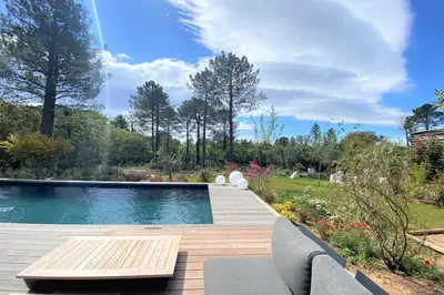 a swimming pool in a yard with a wooden deck at Villa Ribba Di San Gavino in Gialla
