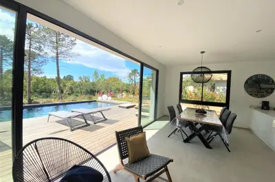 a living room with a table and a pool at Villa Ribba Di San Gavino in Gialla