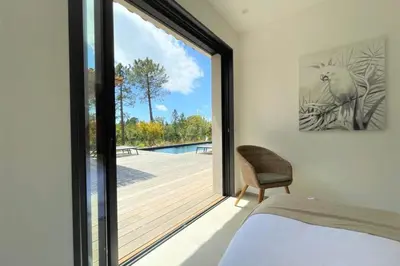 a bedroom with a sliding glass door to a deck at Villa Ribba Di San Gavino in Gialla