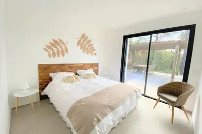 a bedroom with a bed and a chair and a window at Villa Ribba Di San Gavino in Gialla