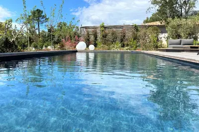 a swimming pool with blue water in a yard at Villa Ribba Di San Gavino in Gialla