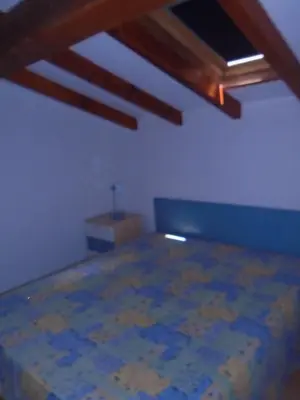 a room with a bed and a wooden ceiling at VARDIOLA/PORTO VECCHIO in Pinarellu