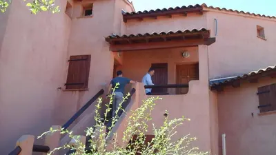 two men standing on the stairs of a building at VARDIOLA/PORTO VECCHIO in Pinarellu