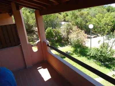 a balcony of a house with a view of a yard at VARDIOLA/PORTO VECCHIO in Pinarellu