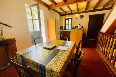 a dining room table with a table cloth on it at Paisible Holidays For 4 Gîte 60 M With Garden ! in Pietrosella