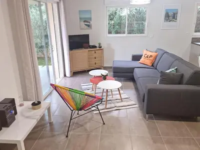 a living room with a couch and a table at Maison pinarello à 200 mètres de la plage in Zonza