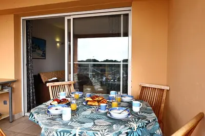 a table with plates of food on top of it at Les Sanguinaires N'16 - T2 Vue Mer, Piscine, Plage in Ajaccio