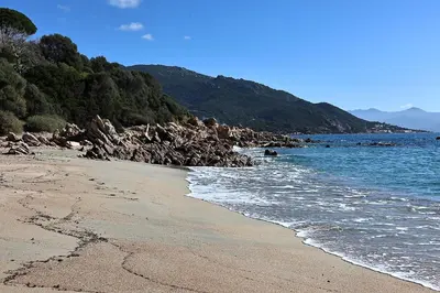 a beach with rocks and the ocean on a sunny day at Les Sanguinaires N'16 - T2 Vue Mer, Piscine, Plage in Ajaccio