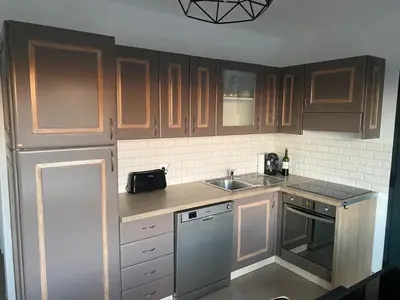 a kitchen with wooden cabinets and a stainless steel dishwasher at Brindingaccia in Propriano