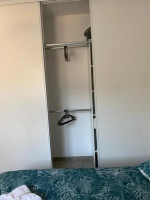 a room with a closet with a ladder and a bed at Brindingaccia in Propriano
