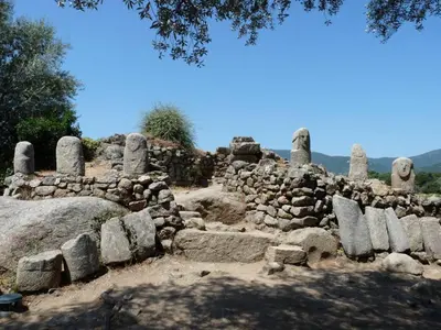 a pile of stone ruins in a field at U Caseddu Di Minnana in Petreto-Bicchisano