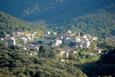 a small town on top of a hill with houses at U Caseddu Di Minnana in Petreto-Bicchisano