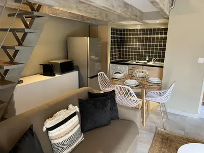a living room with a couch and a table at Appartements St. Pancrace in Corte