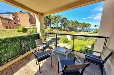 a balcony with chairs and tables and a view of the ocean at Stella - Agosta beach by foot Terrace - by TGB in Porticcio