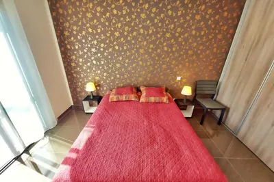 a bedroom with a red bed with two red pillows at Stella - Agosta beach by foot Terrace - by TGB in Porticcio
