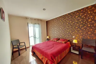 a bedroom with a red bed with a red blanket at Stella - Agosta beach by foot Terrace - by TGB in Porticcio