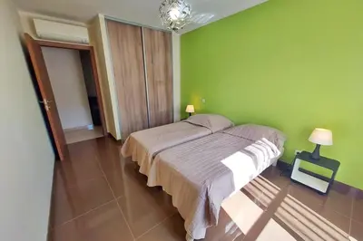 a bedroom with a bed in a green wall at Stella - Agosta beach by foot Terrace - by TGB in Porticcio