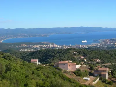 a view of a city and a body of water at Gîtes Sassone, piscine, jacuzzi et vue mer panoramique sur Ajaccio in Alata