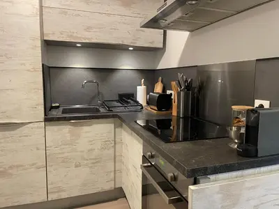 a kitchen with a sink and a counter top at Charmant T2 proche de la plage et au calme in Ajaccio