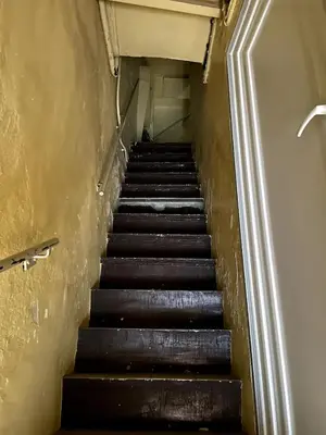 a stairway leading up to a staircase in a building at Appartement T2 Vieux Port d'Ajaccio in Ajaccio
