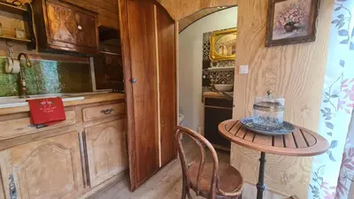 a small table in a kitchen with a small table in a room at La roulotte au coeur du maquis in Carbuccia