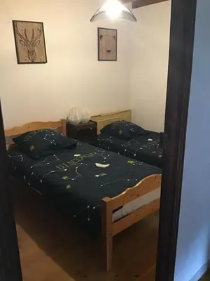 two beds in a room with a mirror at Belle maison de montagne proche Ajaccio in Bastelica