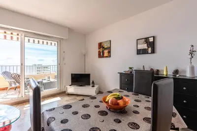 a living room with a bowl of fruit on a table at Ajaccio, Sanguinaires, Hélios, vue mer magnifique, T2 4pers in Ajaccio