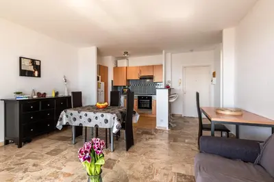 a kitchen and dining room with a table and a table and chairs at Ajaccio, Sanguinaires, Hélios, vue mer magnifique, T2 4pers in Ajaccio