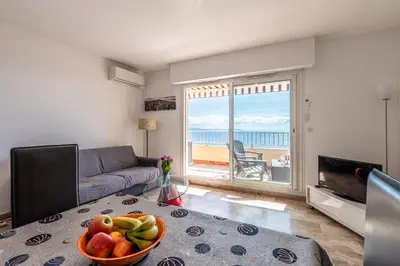 a living room with a table with a bowl of fruit at Ajaccio, Sanguinaires, Hélios, vue mer magnifique, T2 4pers in Ajaccio