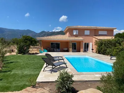 a villa with a swimming pool in front of a house at Villa Chez Géraldine Piscine chauffée, proche plage et rivière in Lecci