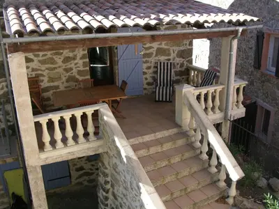 an external view of a house with a staircase and a roof at Maison Le Rêve in Evisa