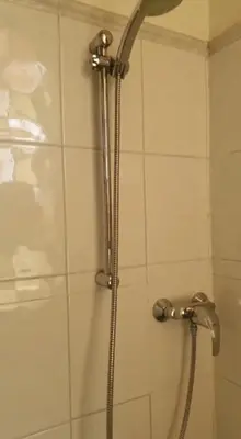 a shower with a shower head in a bathroom at Villa santa karina in Linguizzetta