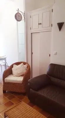 a living room with a couch and a chair at Villa santa karina in Linguizzetta