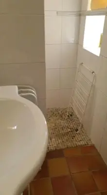 a bathroom with a toilet and a sink and a window at Villa santa karina in Linguizzetta